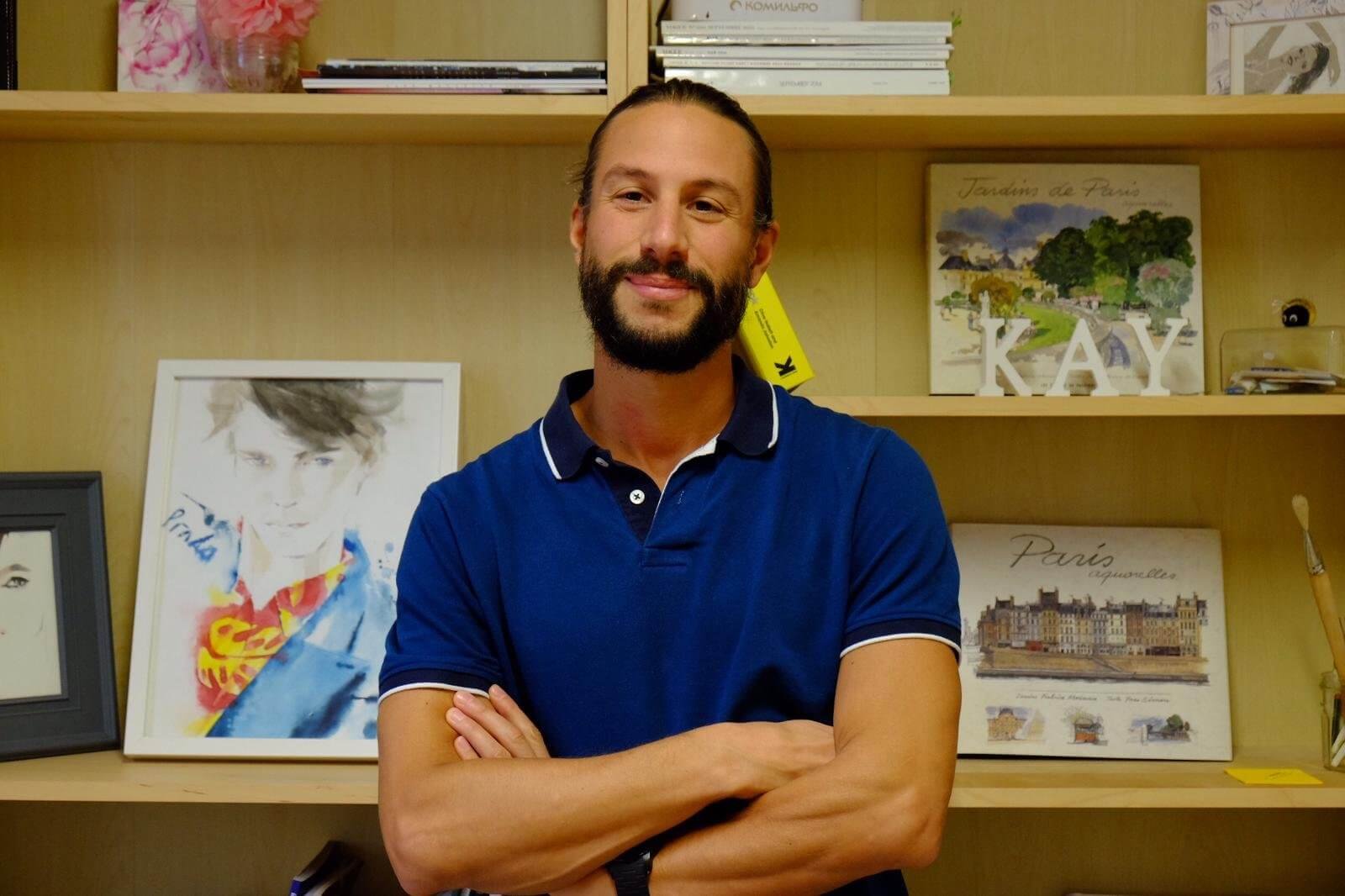 Portrait of a smiling Italian teacher in a classroom at Language Atelier