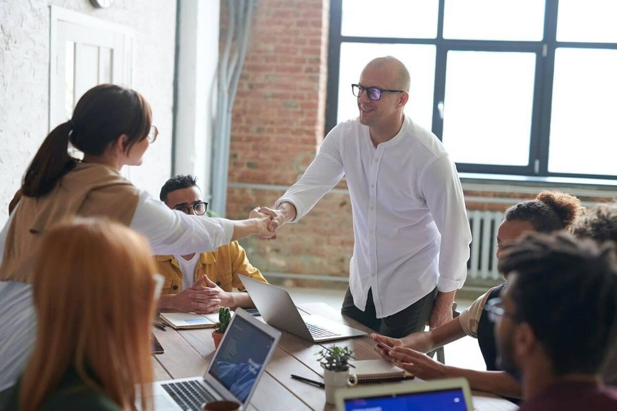 Business team greeting and collaborating during a language training session